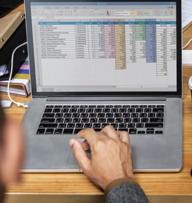Businessman working a on laptop in a meeting